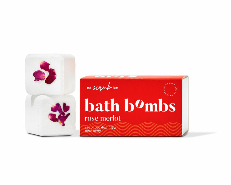 The Scrub Bar’s Rose Merlot floral bath bombs with rose petals, stacked beside bold red, gift-ready packaging.