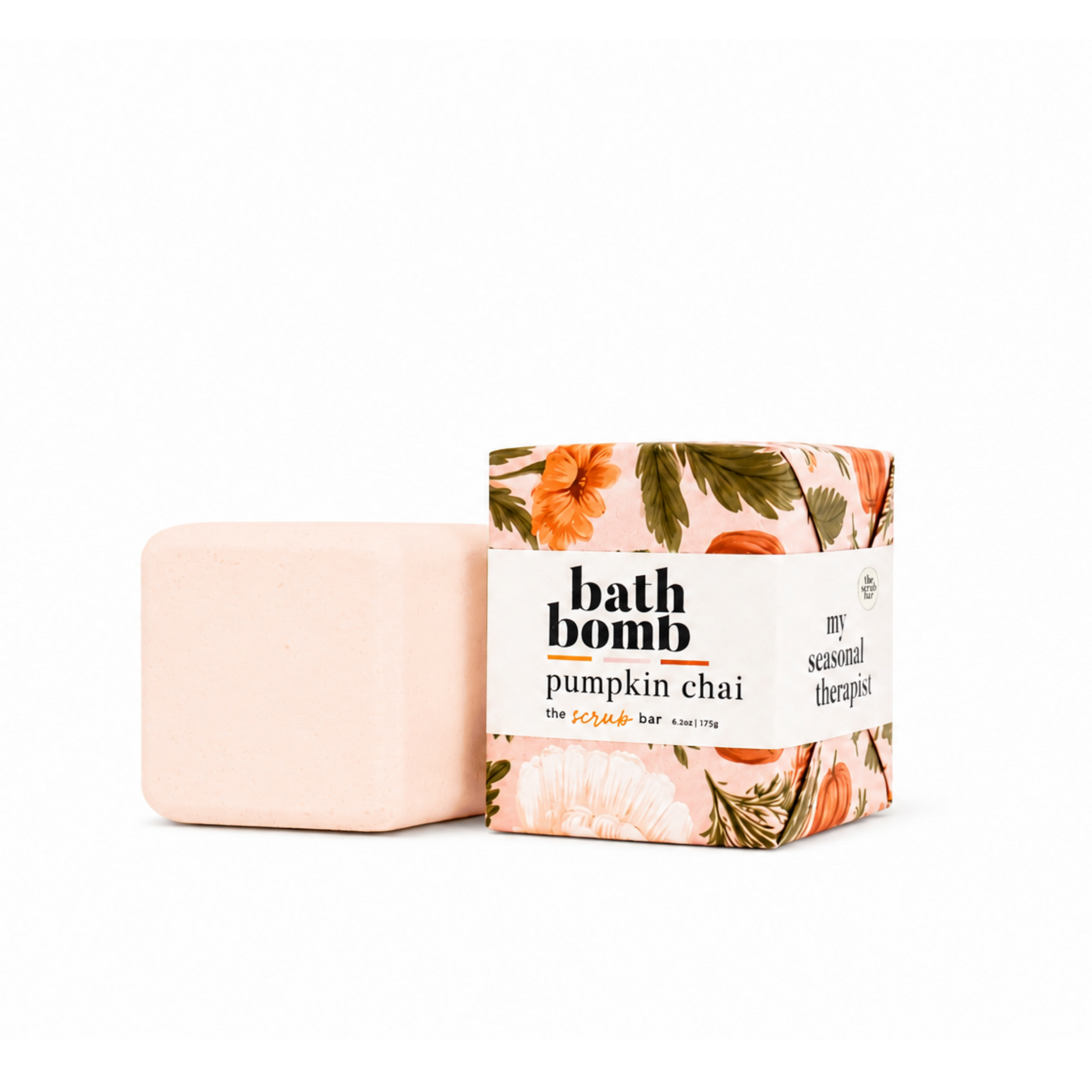 Pumpkin Chai bath bomb beside floral gift-ready packaging from The Scrub Bar.